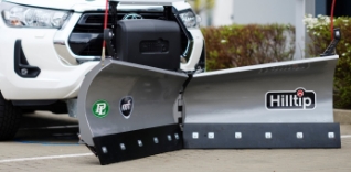 Sněžná radlice Hilltip před bílým autem.